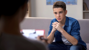 Teen talks to therapist during trauma therapy